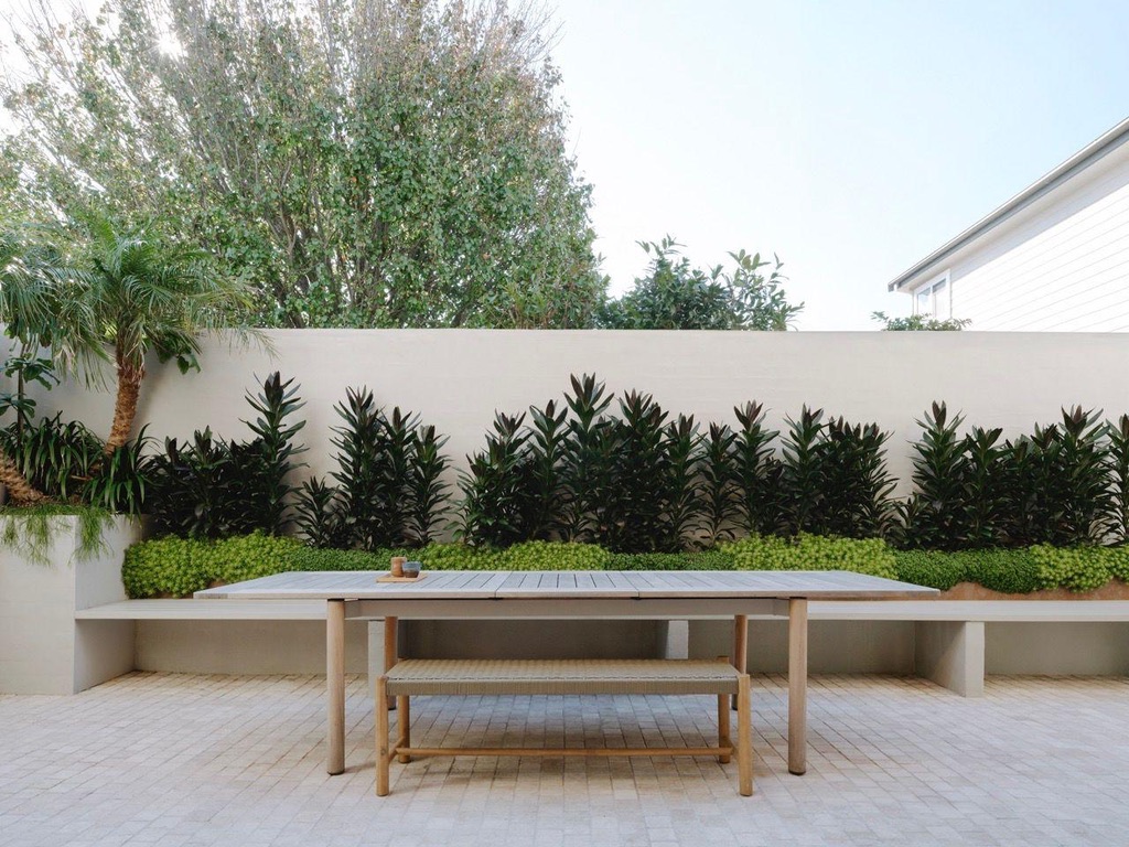 Rear courtyard — outdoor dining with painted render wall