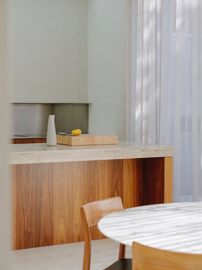 Kitchen island detail — warm timber, stone top