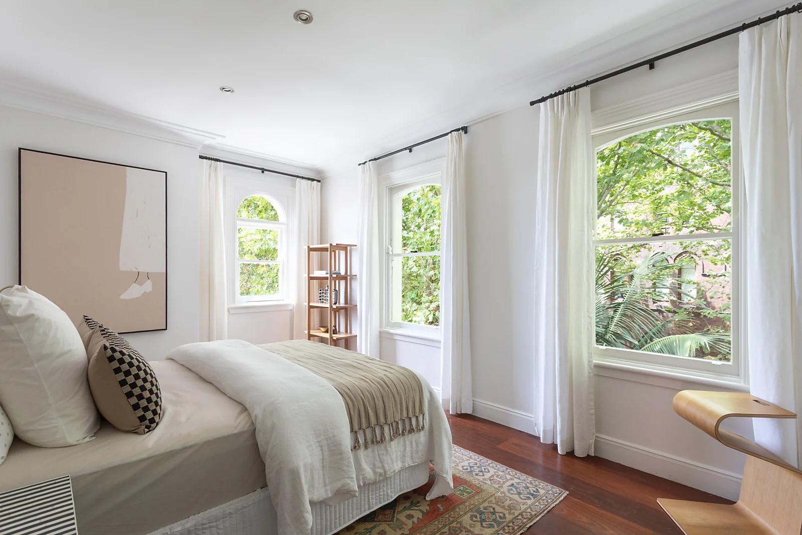 Bedroom with white walls and arched windows