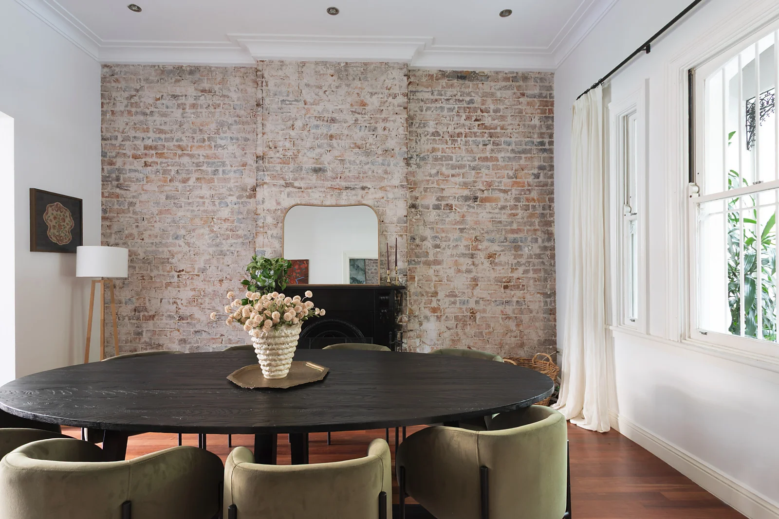 Dining room with round table and brick wall